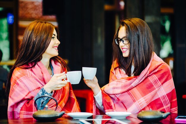 two-young-beautiful-girls-gossiping-terrace-with-cup-coffee_1153-8910[1]